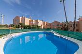 Spacious family townhouse in a gated community with communal gardens and pools within easy walking distance of local amenities, Estepona